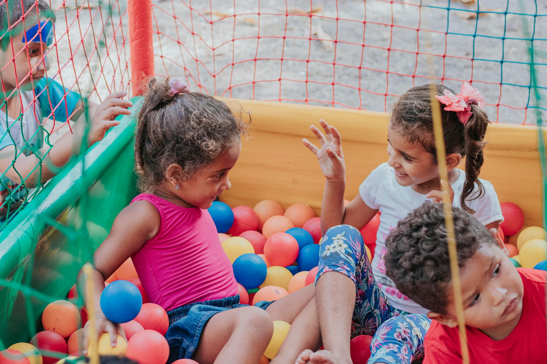 girl in pink tank top sitting on yellow inflatable ring
